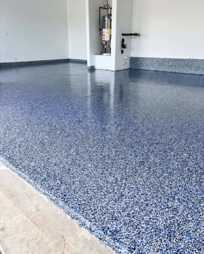 Blue flake polyaspartic garage floor with a high-gloss finish